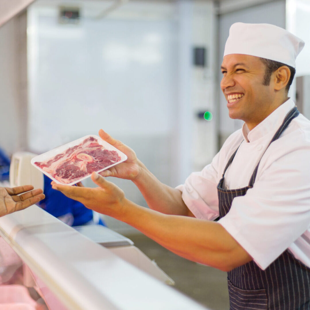 middle aged butcher serving customer Shane's Meat Market